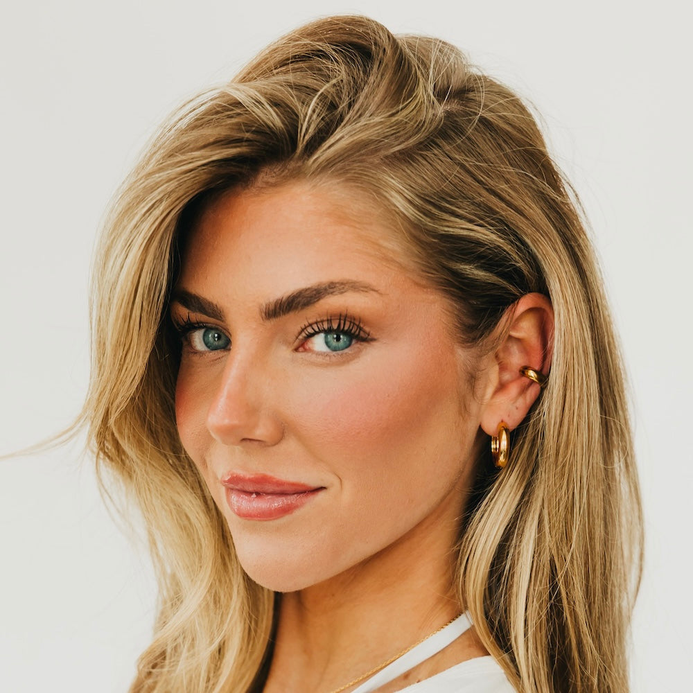 Gold hoop earrings on model, front view with two hoops visible