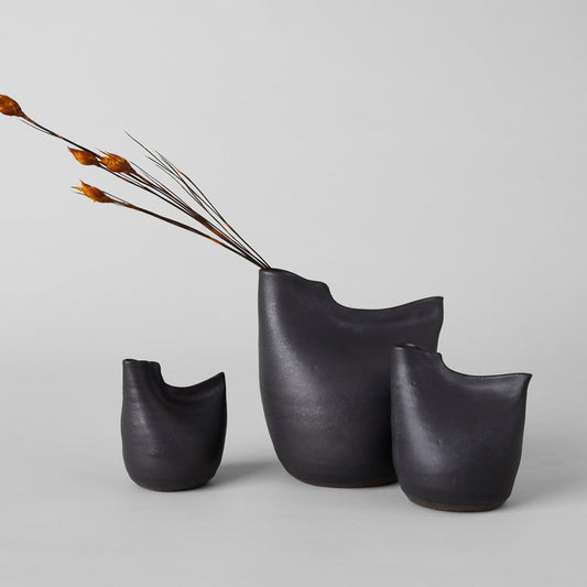 Matte black bird vase set of three, with curved openings and arched silhouette.