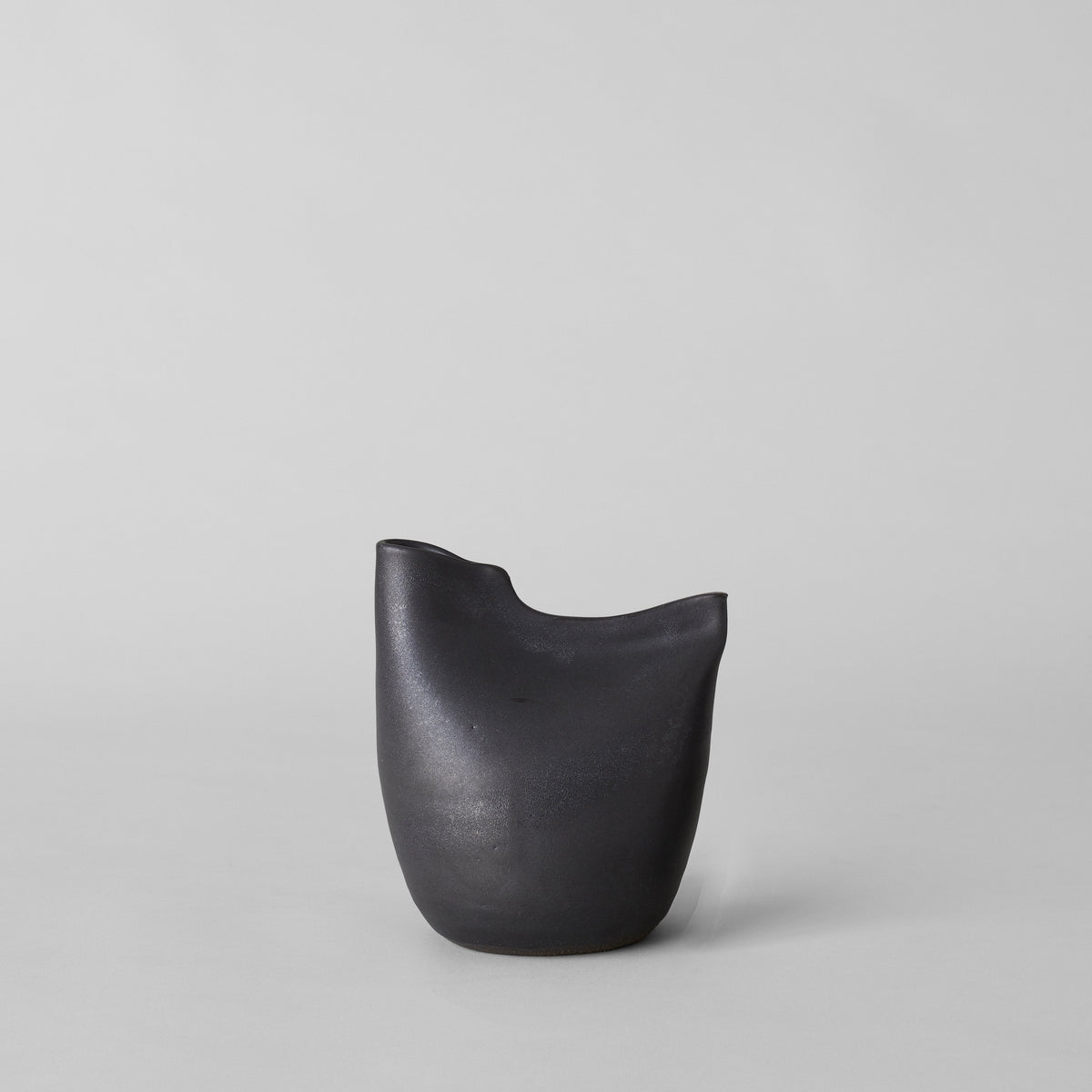 Matte black bird vase with smooth rounded body and curved rim opening.