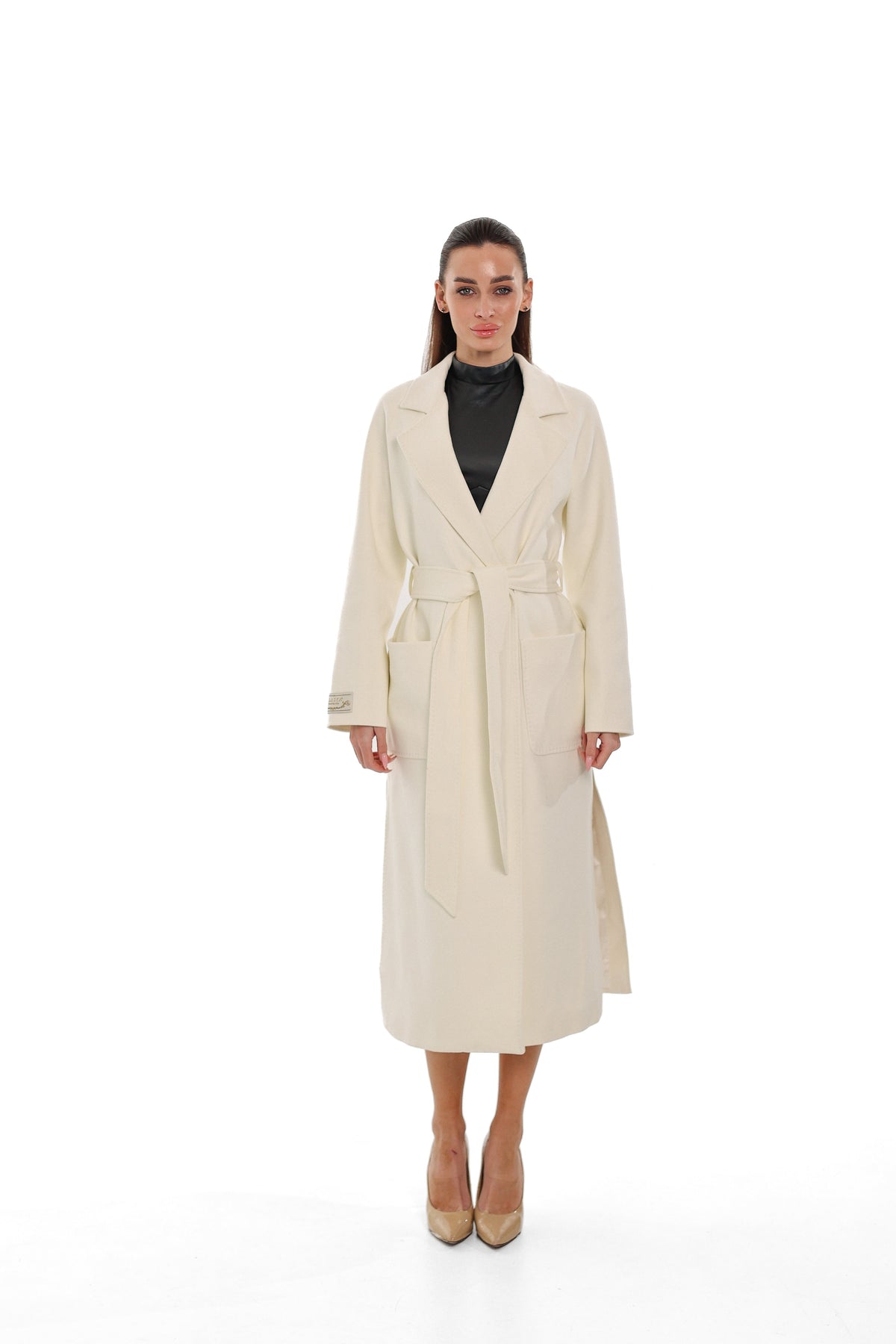 Front view of the ivory belted overcoat with long sleeves and patch pockets