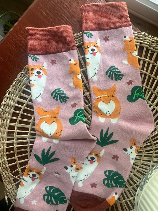 Corgi socks with pink cuffs, white base, orange dog and green leaf pattern