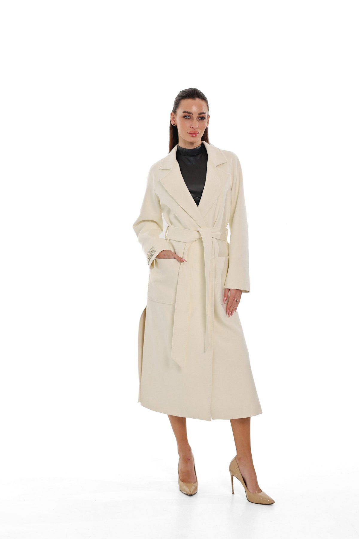 Ivory long overcoat with notched lapels, tie belt and front patch pockets