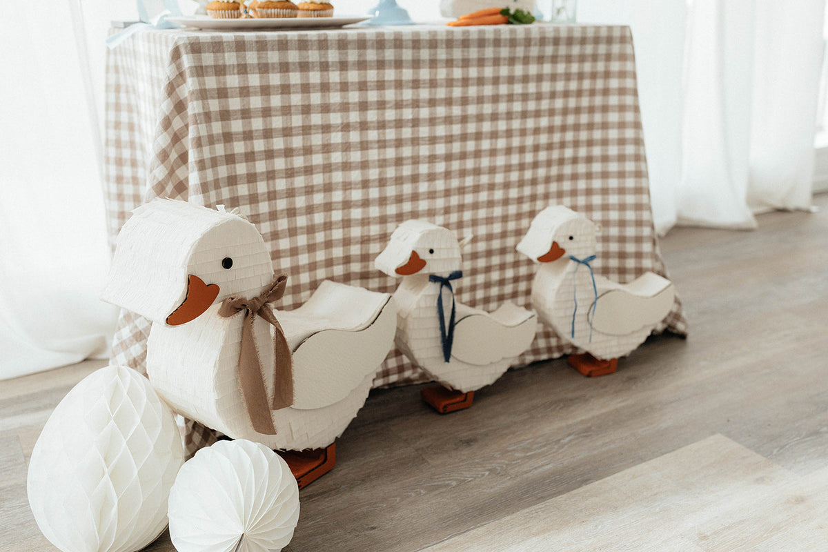 Duck piñata set with white duck shapes and ribbon details