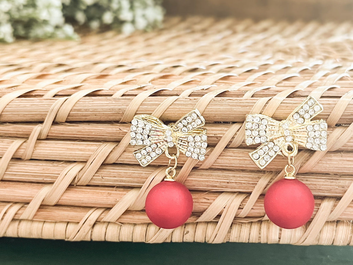 Two gold bow Christmas bulb ornaments with red bead drops, rhinestone center loops