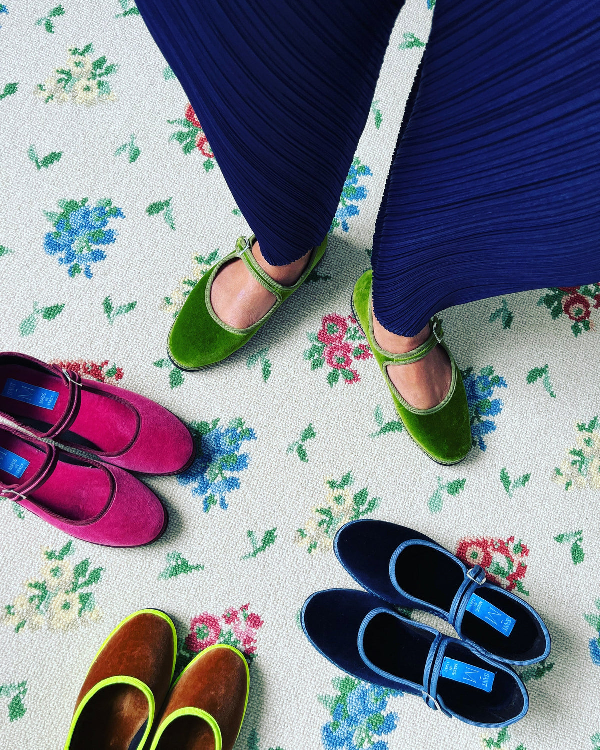 Green Mary Jane flats with ankle strap, feet visible