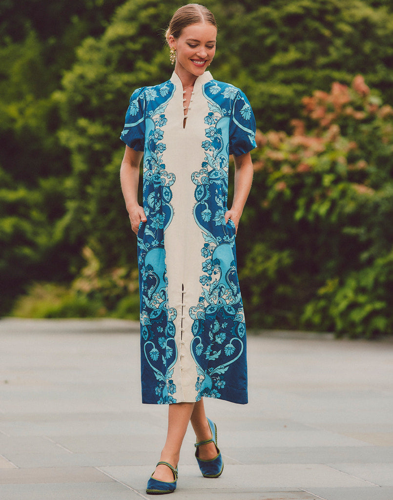 Blue patterned dress with green-trim Mary Jane shoes, full-body side view