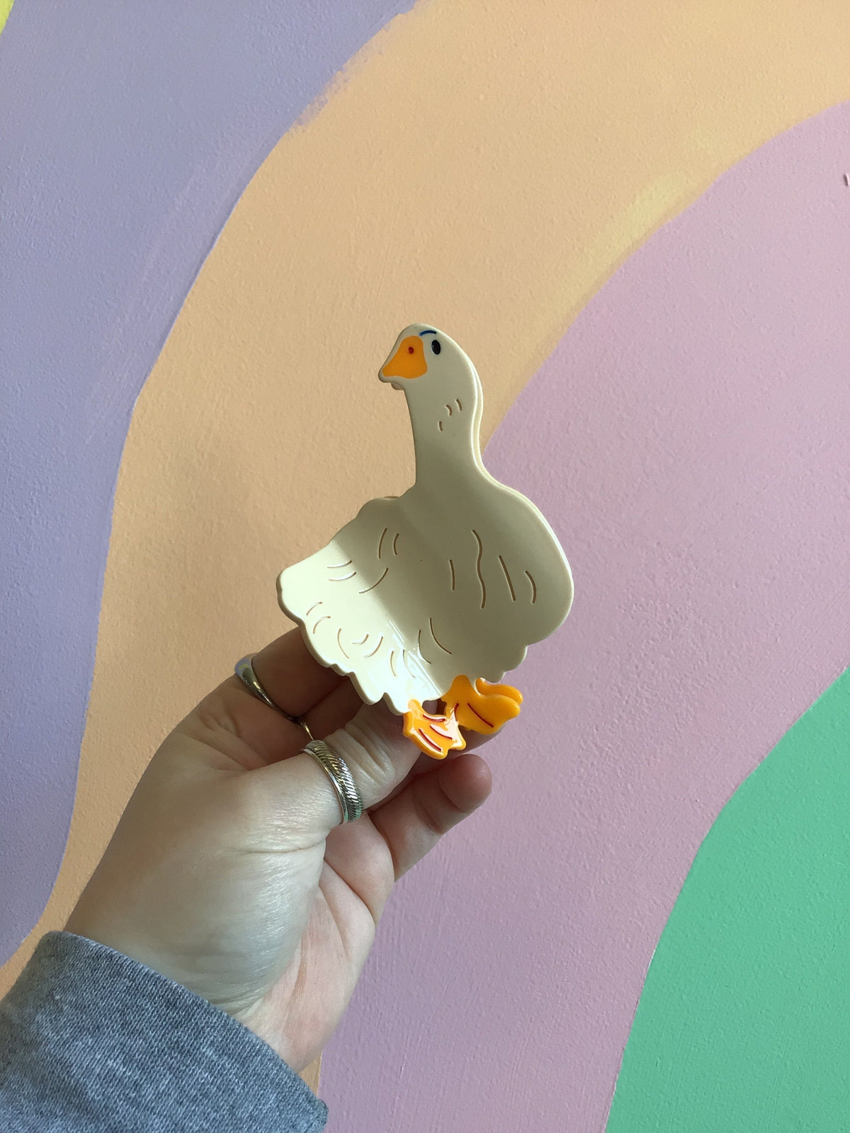 White duck hair claw with orange beak and feet, glossy cartoon style