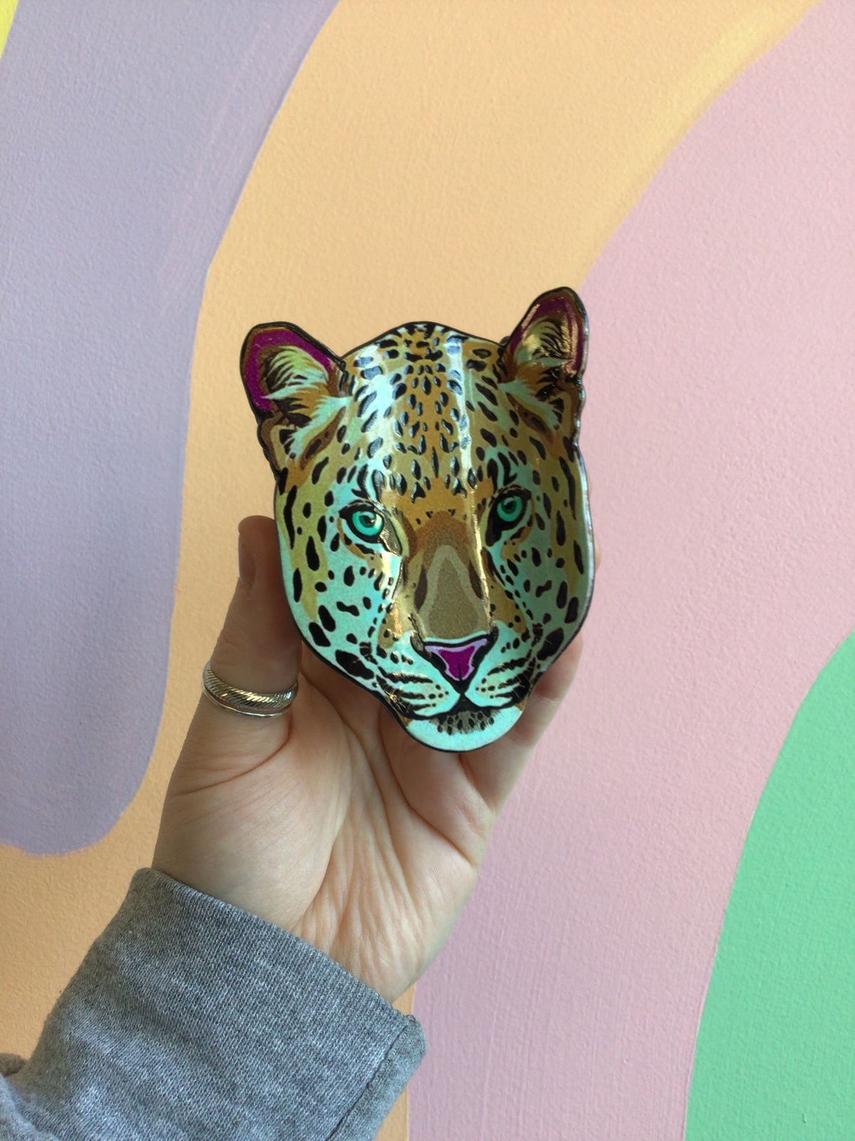 Leopard face hair claw with multicolor ears, blue-green eyes, and detailed spots