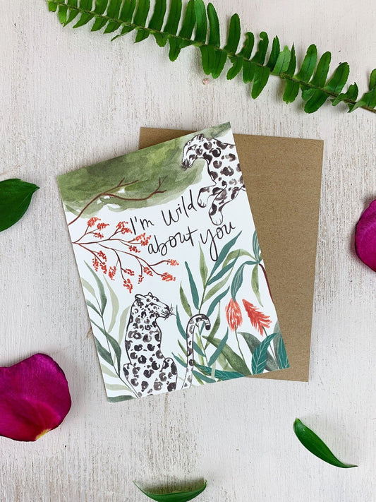 Jungle-themed greeting card with leopard print, tropical leaves, and 'I'm wild about you'.