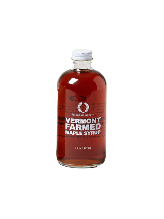 Maple syrup bottle with Vermont Farmed label, plastic cap, amber-red syrup