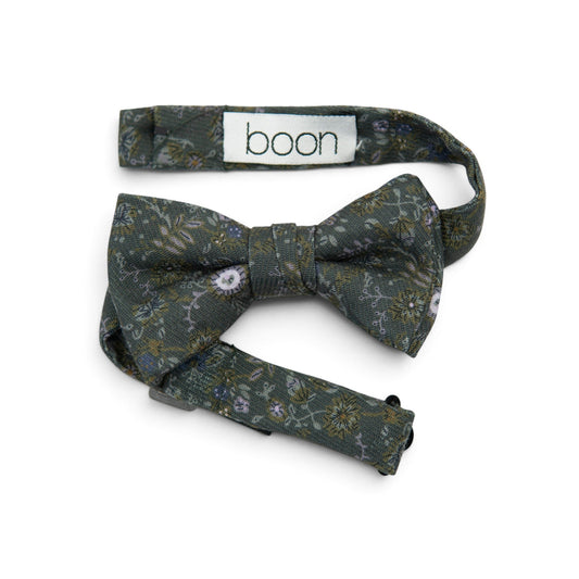 Dark green boys bow tie with floral and leaf pattern; visible branding tag "boon"