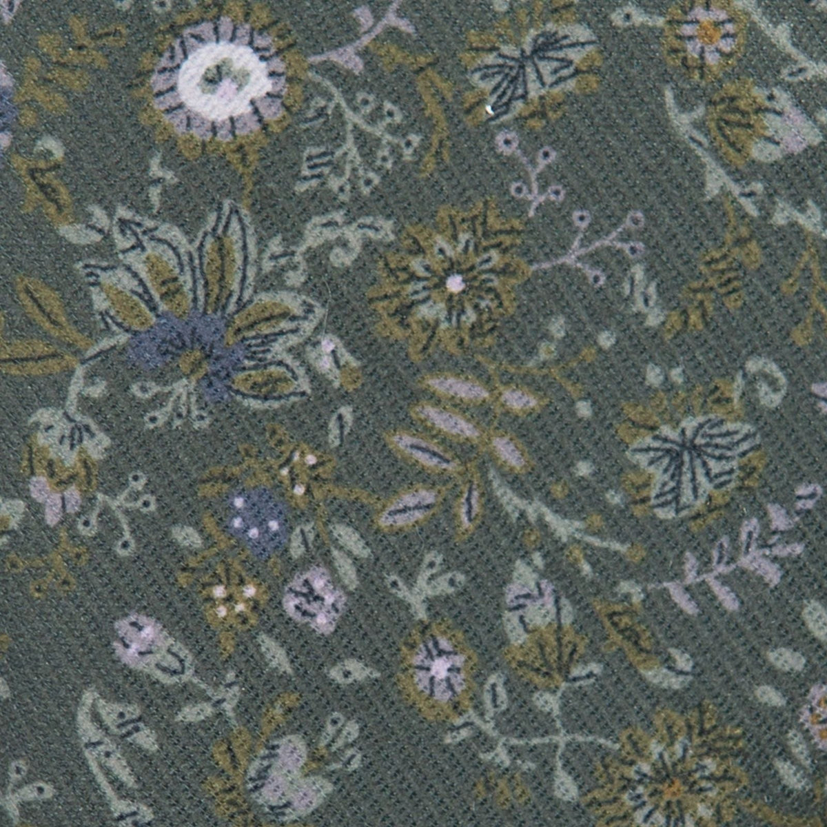 Close-up teal hair bow fabric with embroidered floral and leaf pattern