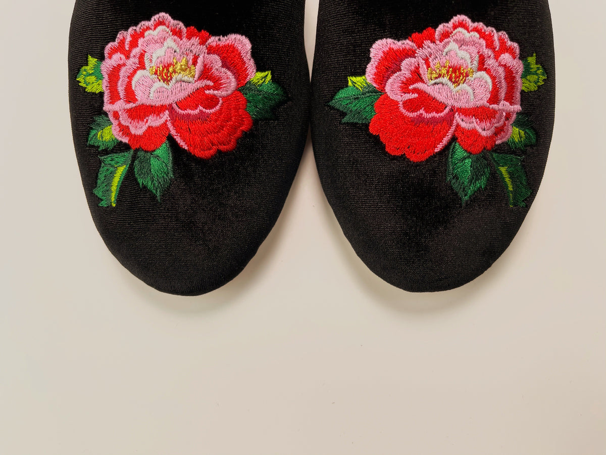 Black velvet mule slippers featuring two peony embroidered flowers