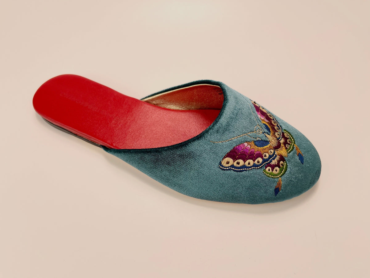 Single teal velvet mule slipper with butterfly embroidery and red lining