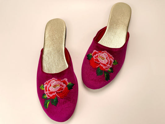 Fuchsia velvet mule slippers with peony embroidery and gold-toned insoles, side view
