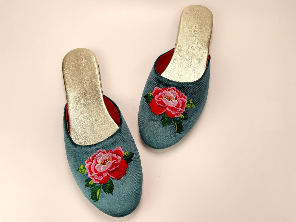 Pair of teal velvet mule slippers with red peony embroidery and gold-toned insoles