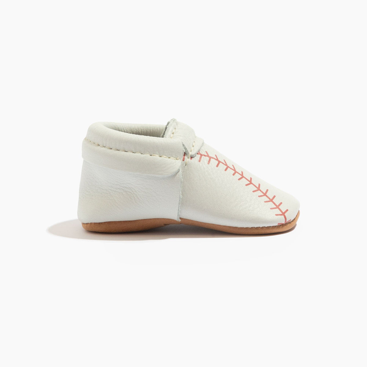 White baby baseball shoes with side panel strap and red stitched baseball pattern