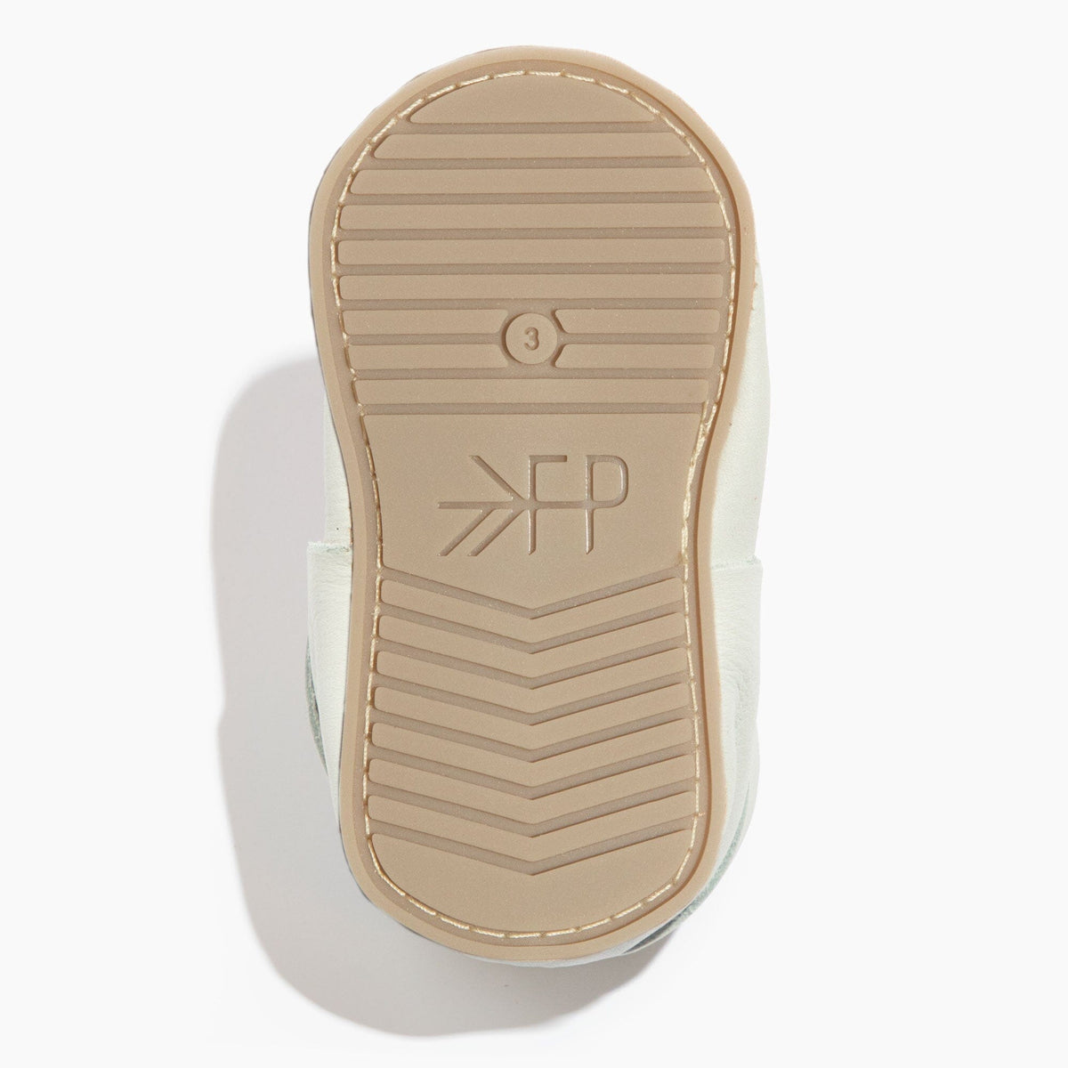 White baby shoe outsole with ribbed grip tread and molded logo