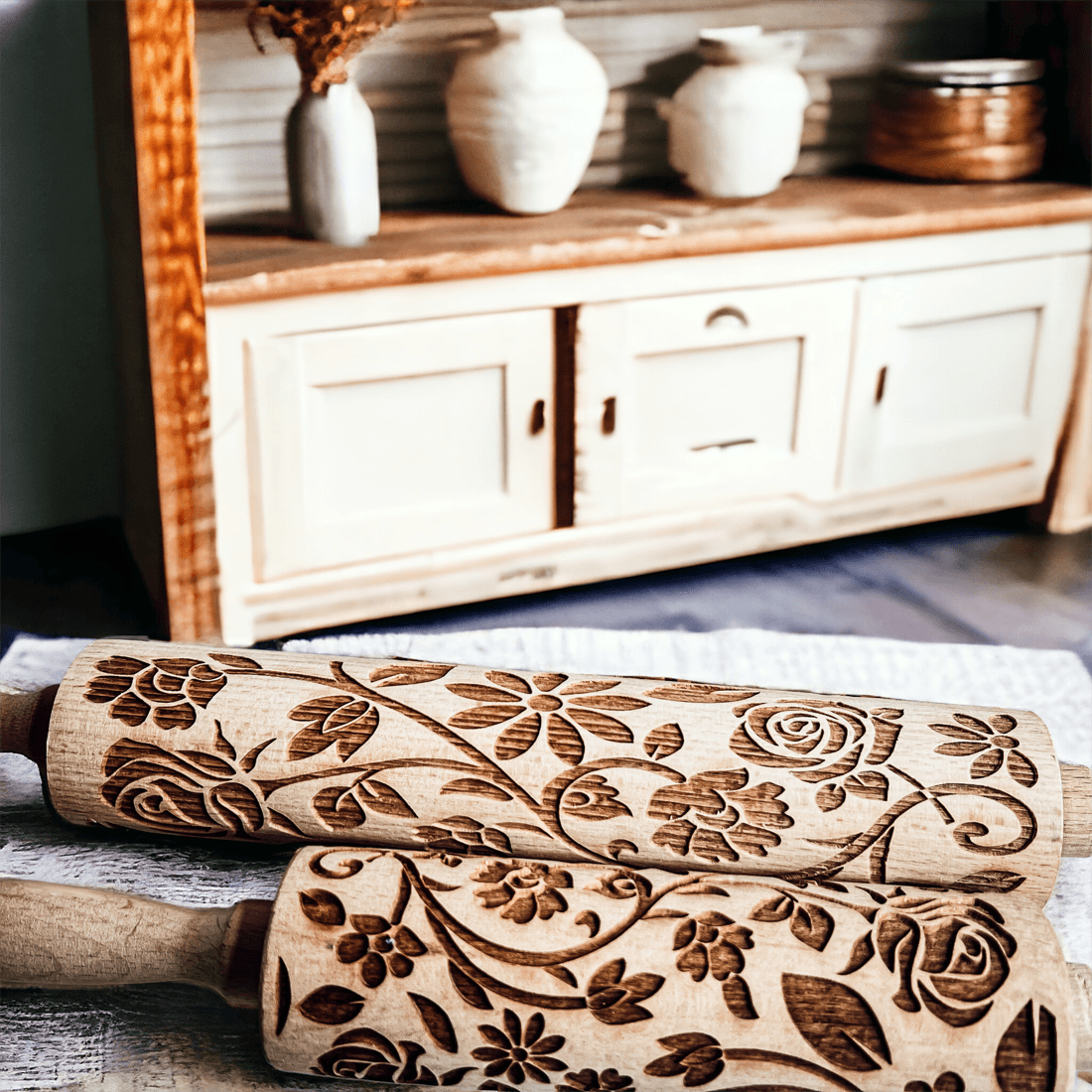 Close-up embossed wood rolling pin with detailed floral scrollwork pattern