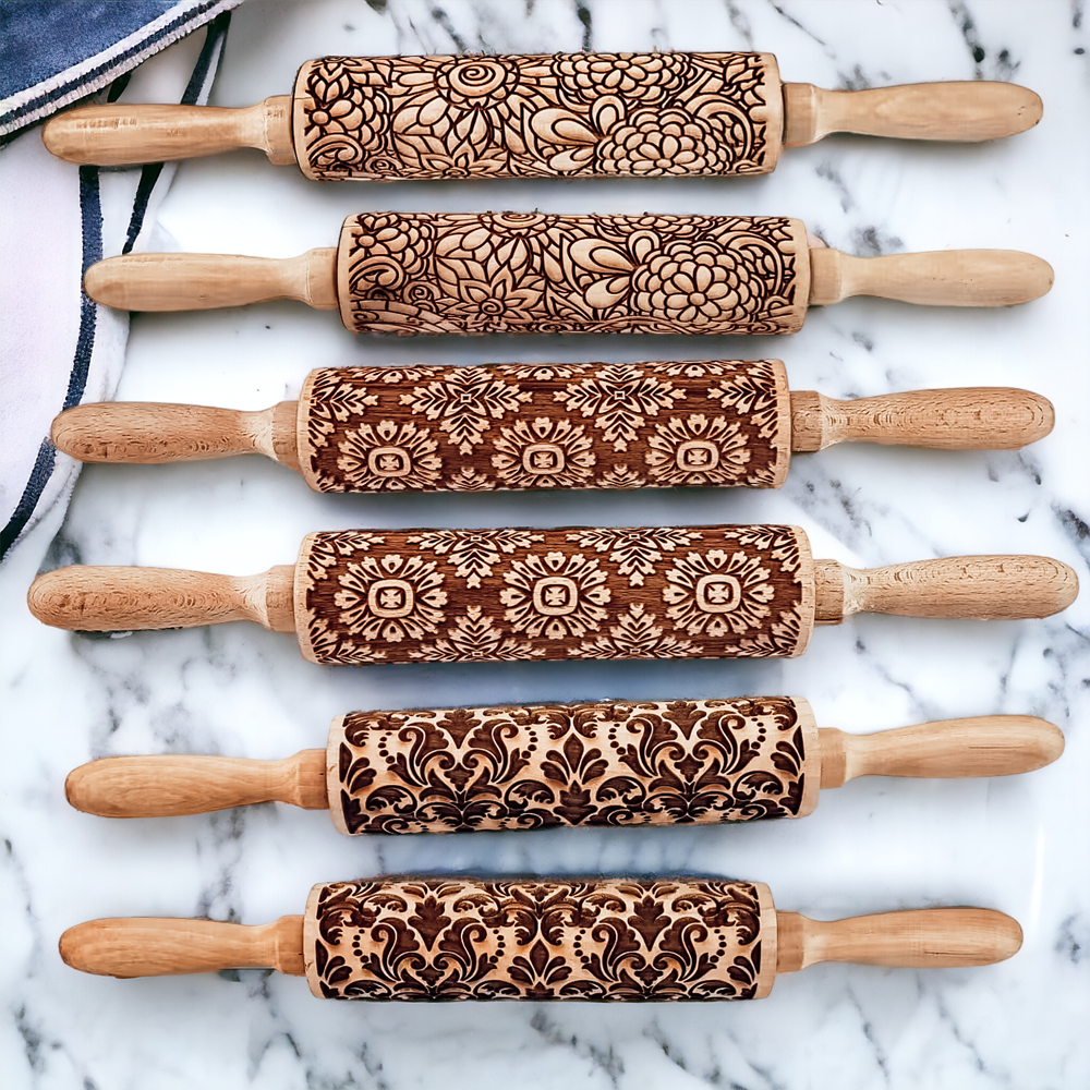 Decorative rolling pin set with wood handles and brown patterned sleeves on marble