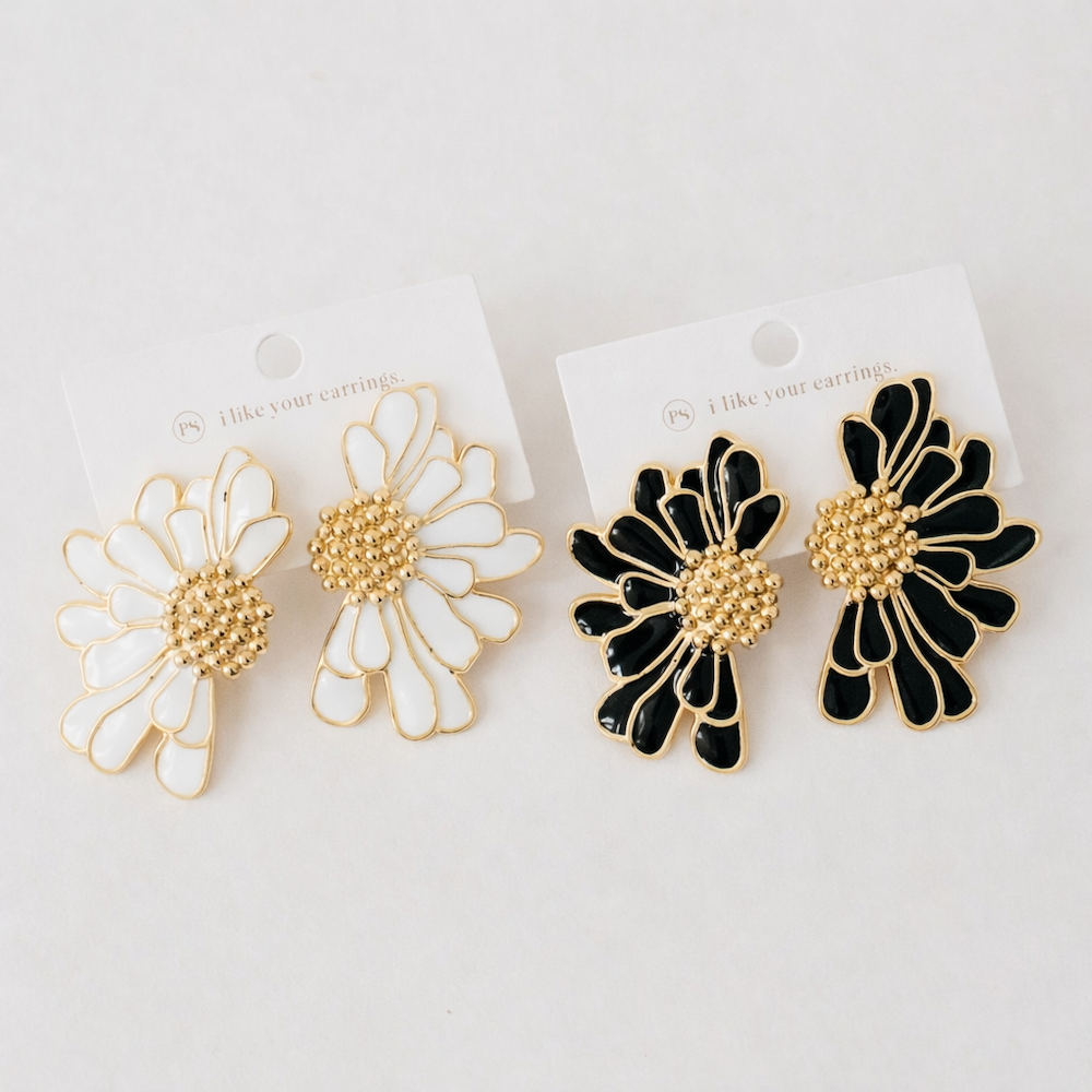Pair of flower stud earrings: white and black enamel petals with gold centers
