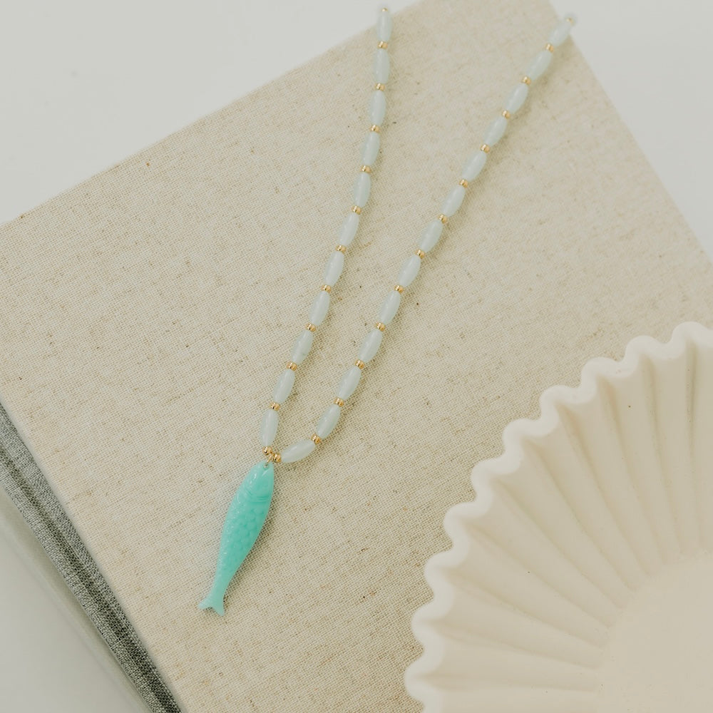 Resin fish charm necklace with turquoise tail pendant and white bead strand