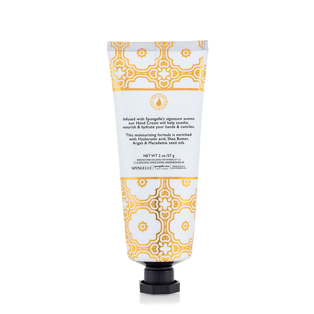 Hand cream tube back view, white with orange geometric pattern and black pump cap