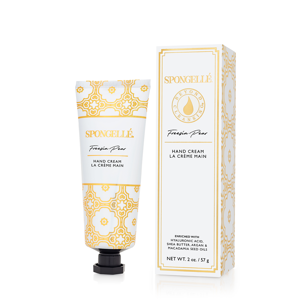 Hand cream tube with orange-and-white geometric pattern and black pump cap
