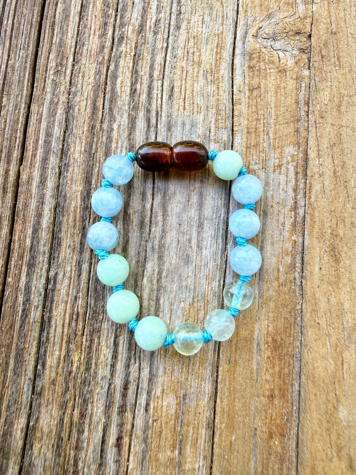 Aqua and light blue beaded bracelet with two dark brown center beads
