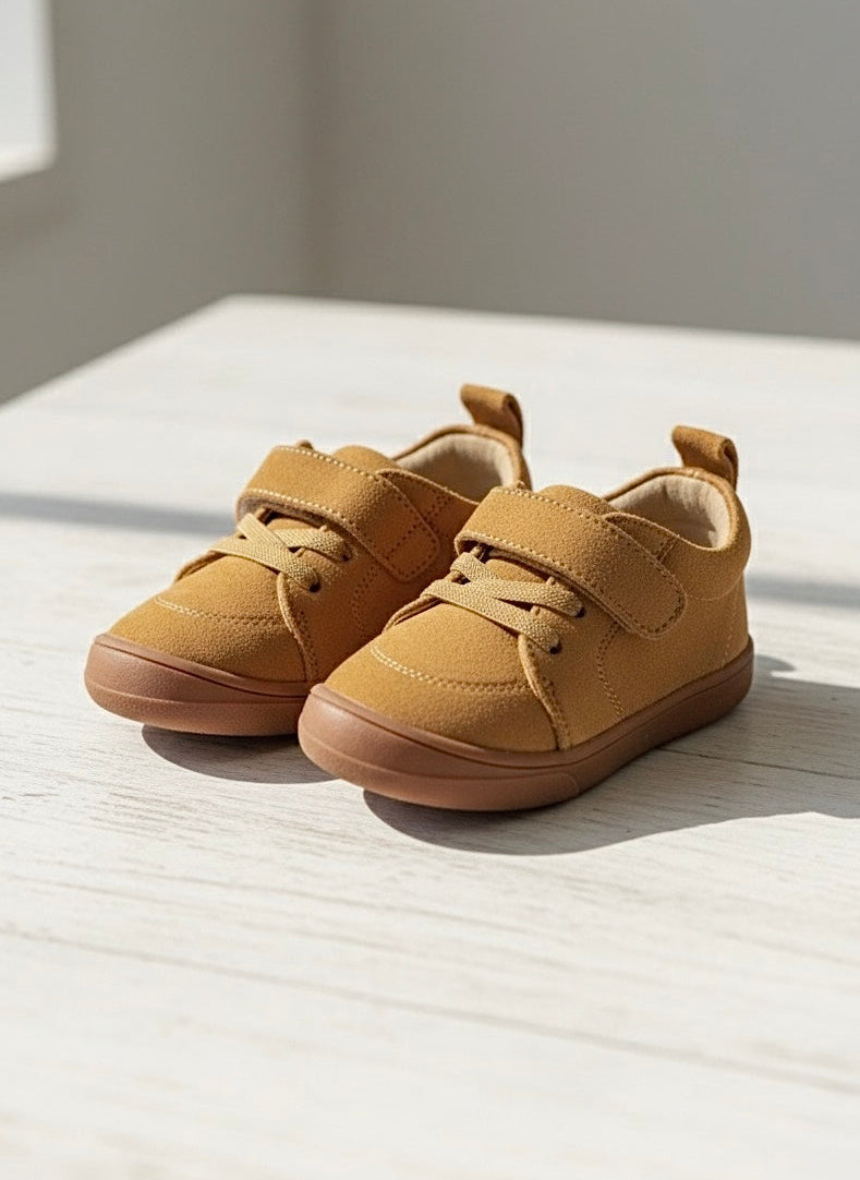 Kids' tan suede lace-up sneakers with cushioned collar and flexible sole