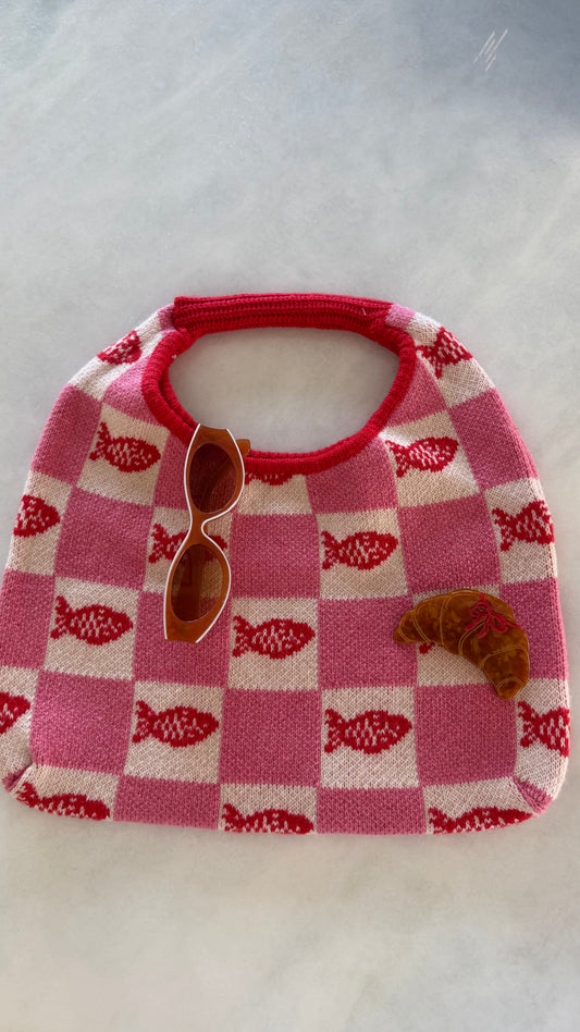 Pink and cream fish-checker tote bag with red rounded top and handle
