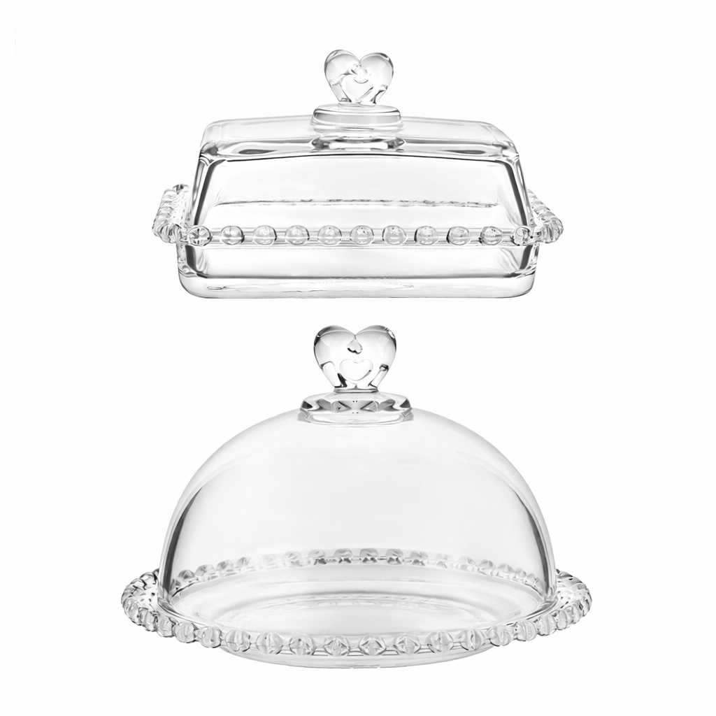 Clear glass covered dishes in rectangular and round shapes, both with heart-shaped knobs
