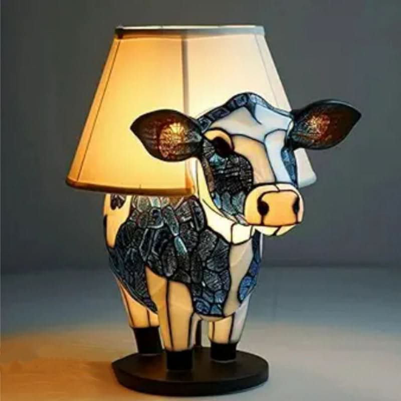 Cow-shaped table lamp with a cream shade and stained glass body