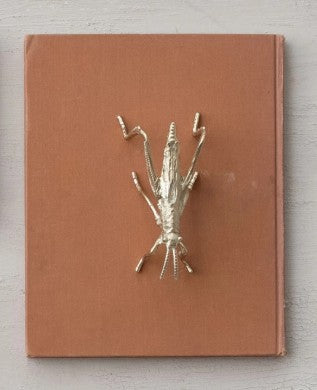 Gold-finished pewter grasshopper ornament with raised legs and antennae