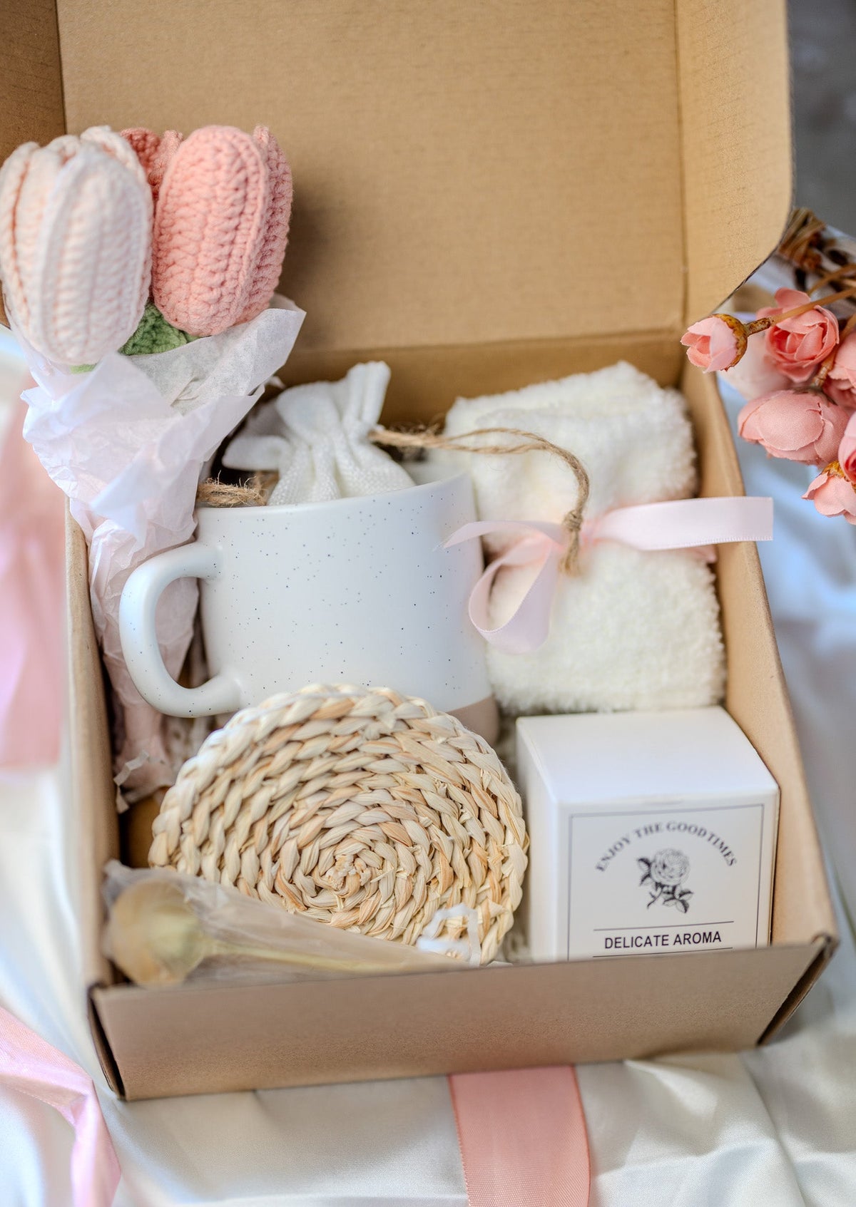 Self-care gift box with white mug, terry washcloth, round woven sponge, and delicate aroma box