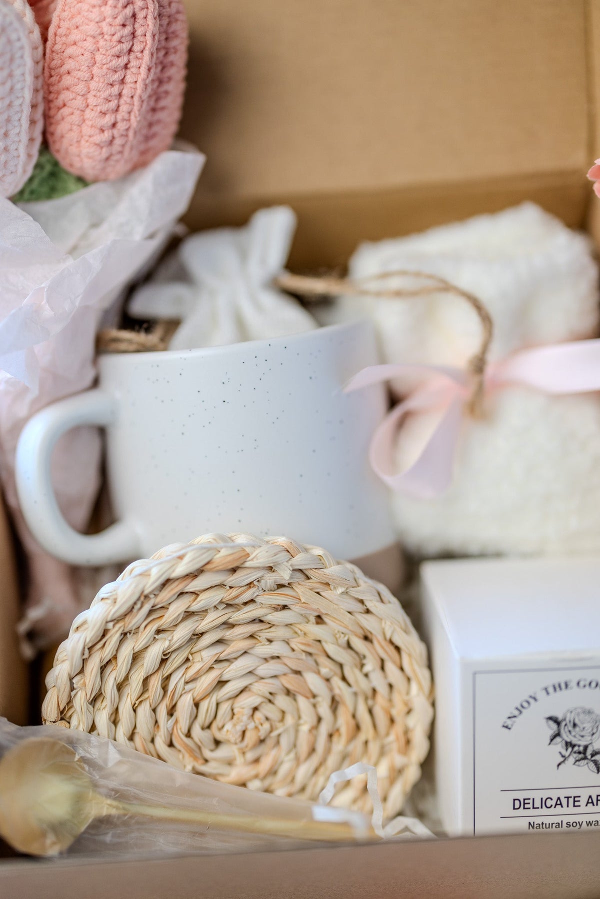Self-care gift box showing white mug, round woven sponge, and delicate aroma candle box