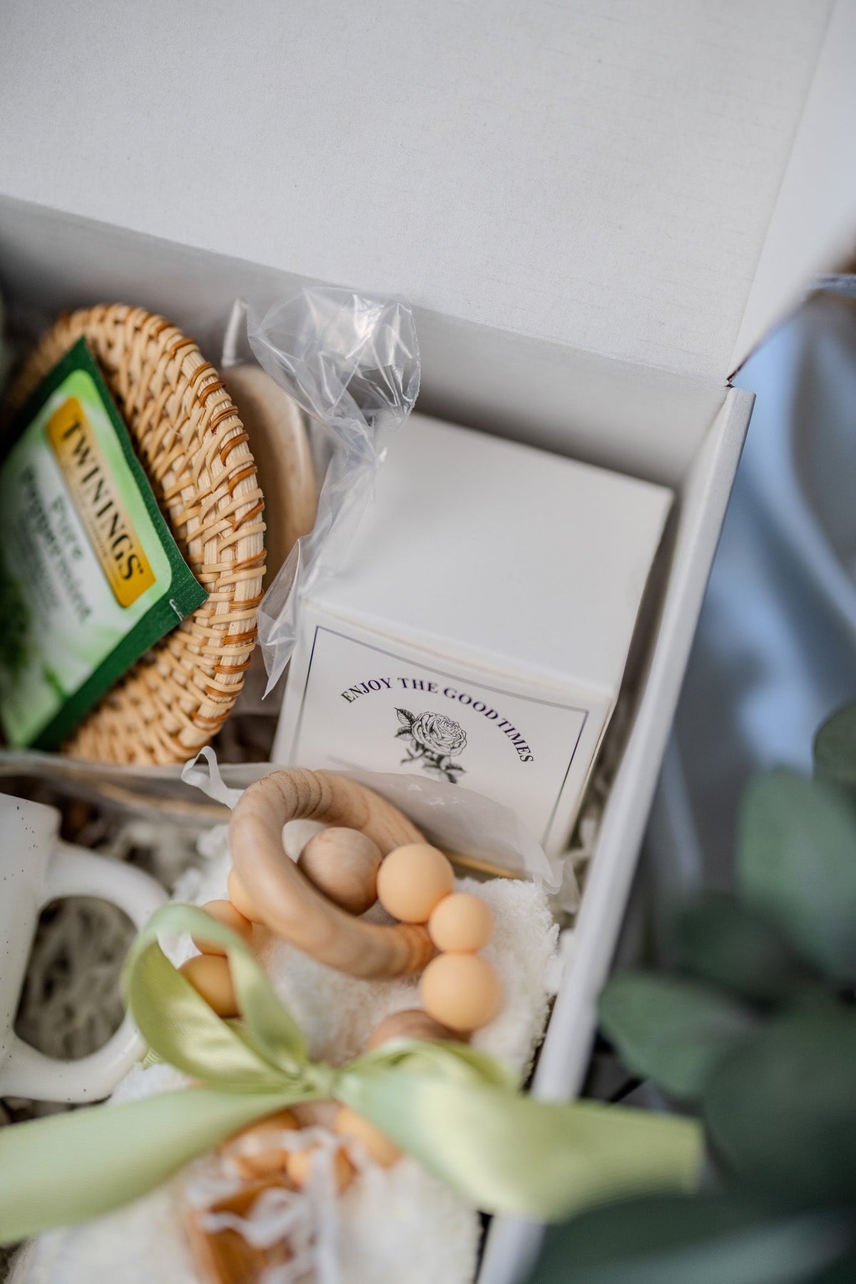 Self-care gift box detail with woven sponge, wooden bead soap, and aroma box