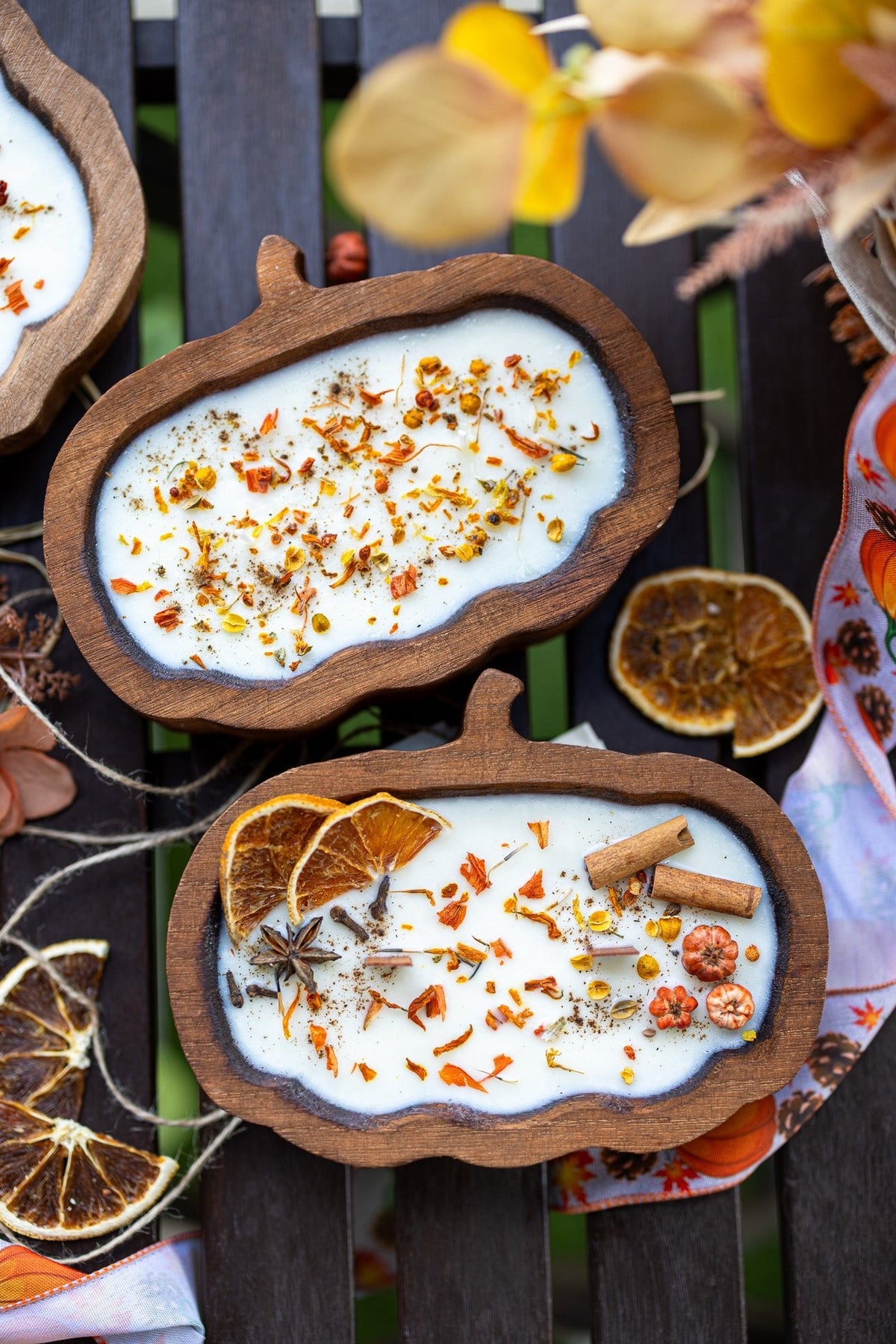 Wooden pumpkin dough bowl candle with cinnamon sticks and orange spice confetti in wax