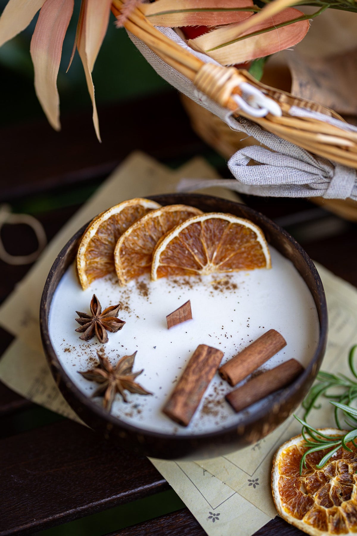 Dark bowl coconut candle with orange slices, cinnamon sticks, and star anise