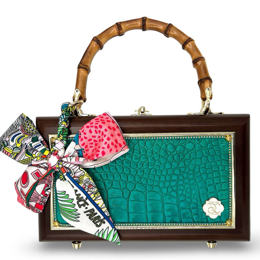 Gator Glam Bag with teal embossed panel, bamboo handle, gold hardware, and colorful scarf tied at side
