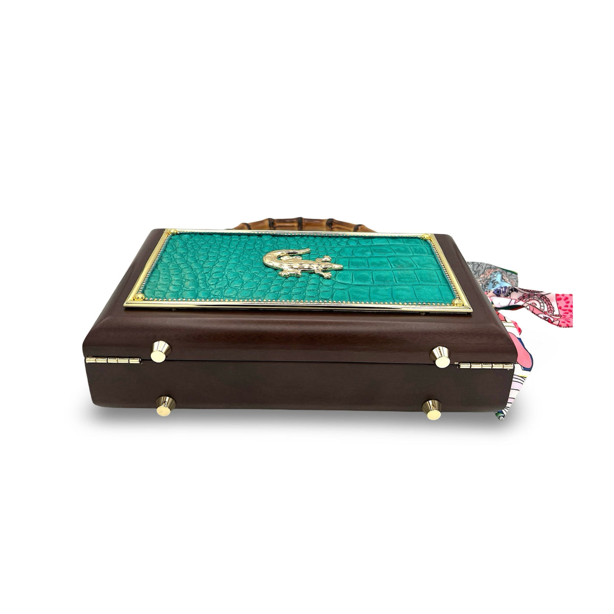 Gator Glam Bag shown from the side, with dark wood case, teal panel, bamboo handle, and scarf