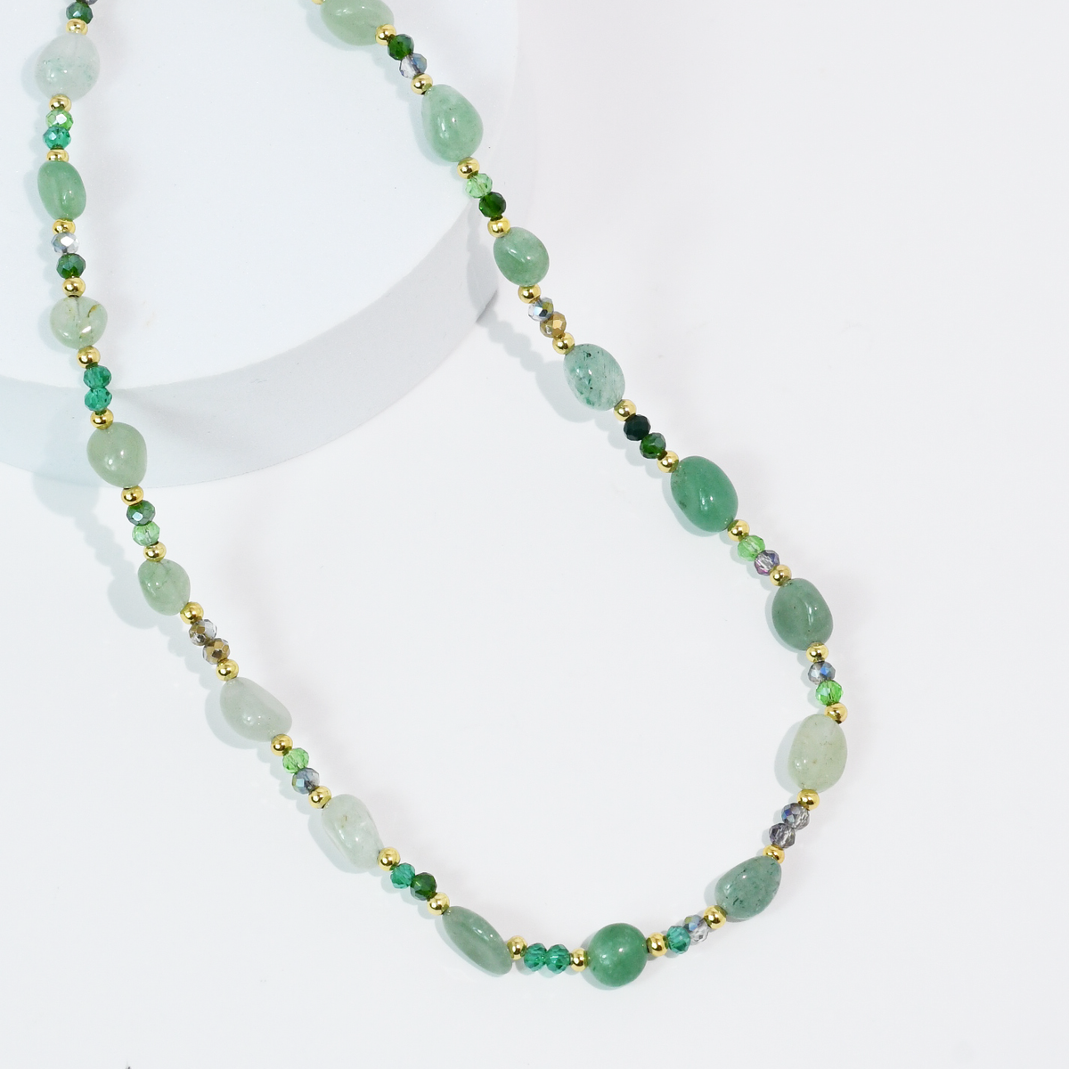 Beaded green gemstone-style necklace with oval beads and gold-tone bead spacers.