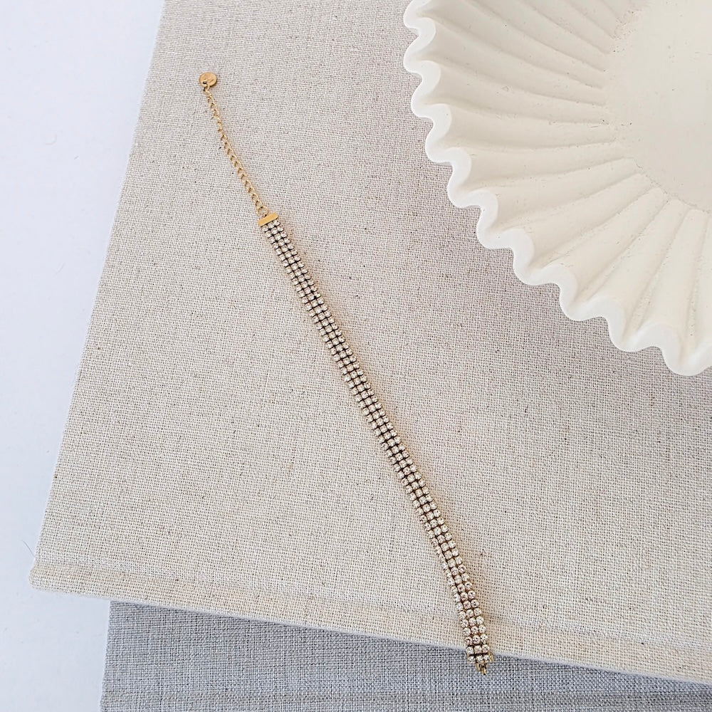 Gold rhinestone tennis bracelet with drop chain detail