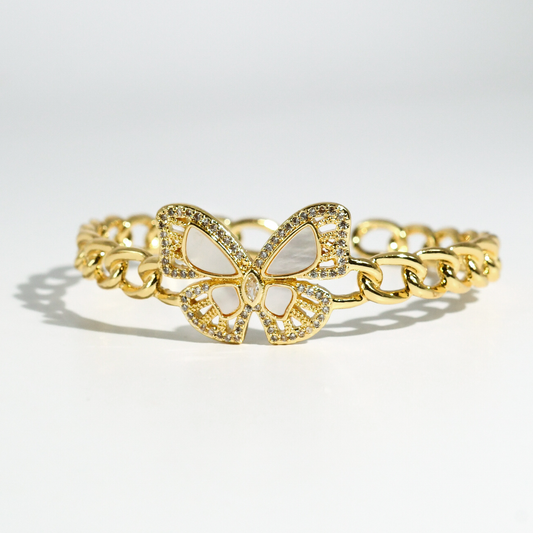 Gold-tone wrap bangle with butterfly charm and clear rhinestone accents.