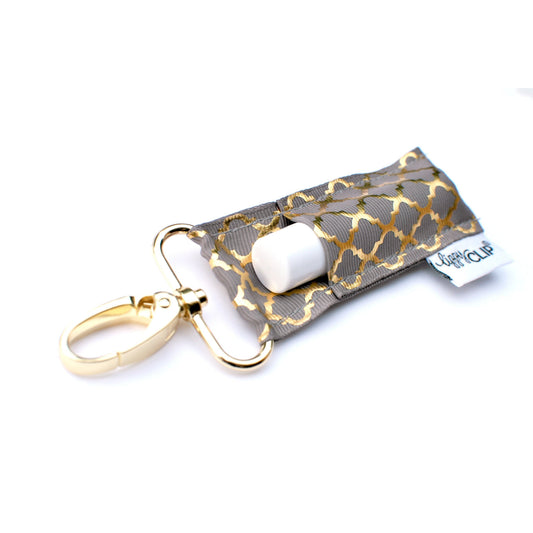 Gold quatrefoil fabric LippyClip® lip balm holder with white lip balm and key clip