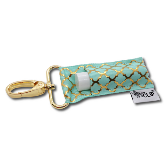 LippyClip® lip balm holder with aqua fabric and gold quatrefoil design, gold keychain clip