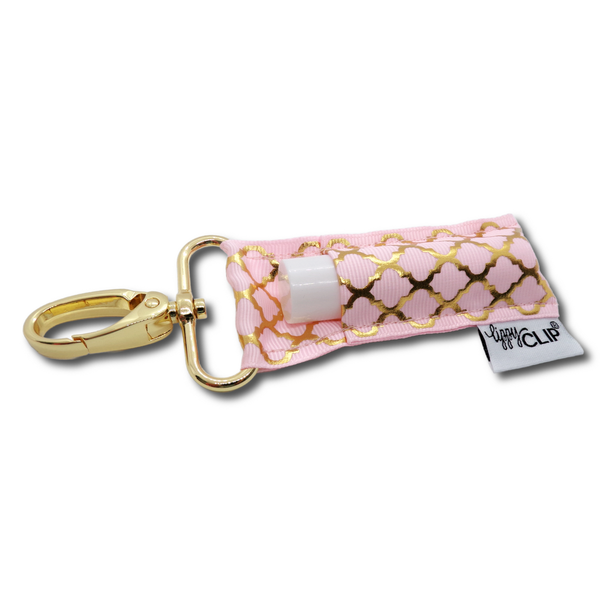 Light pink lip balm holder with gold quatrefoil, white insert, and gold keychain clip