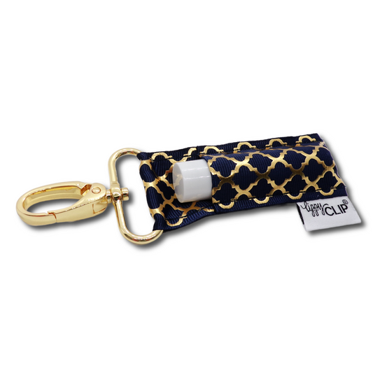 Navy fabric LippyClip lip balm holder with gold quatrefoil pattern and clip ring