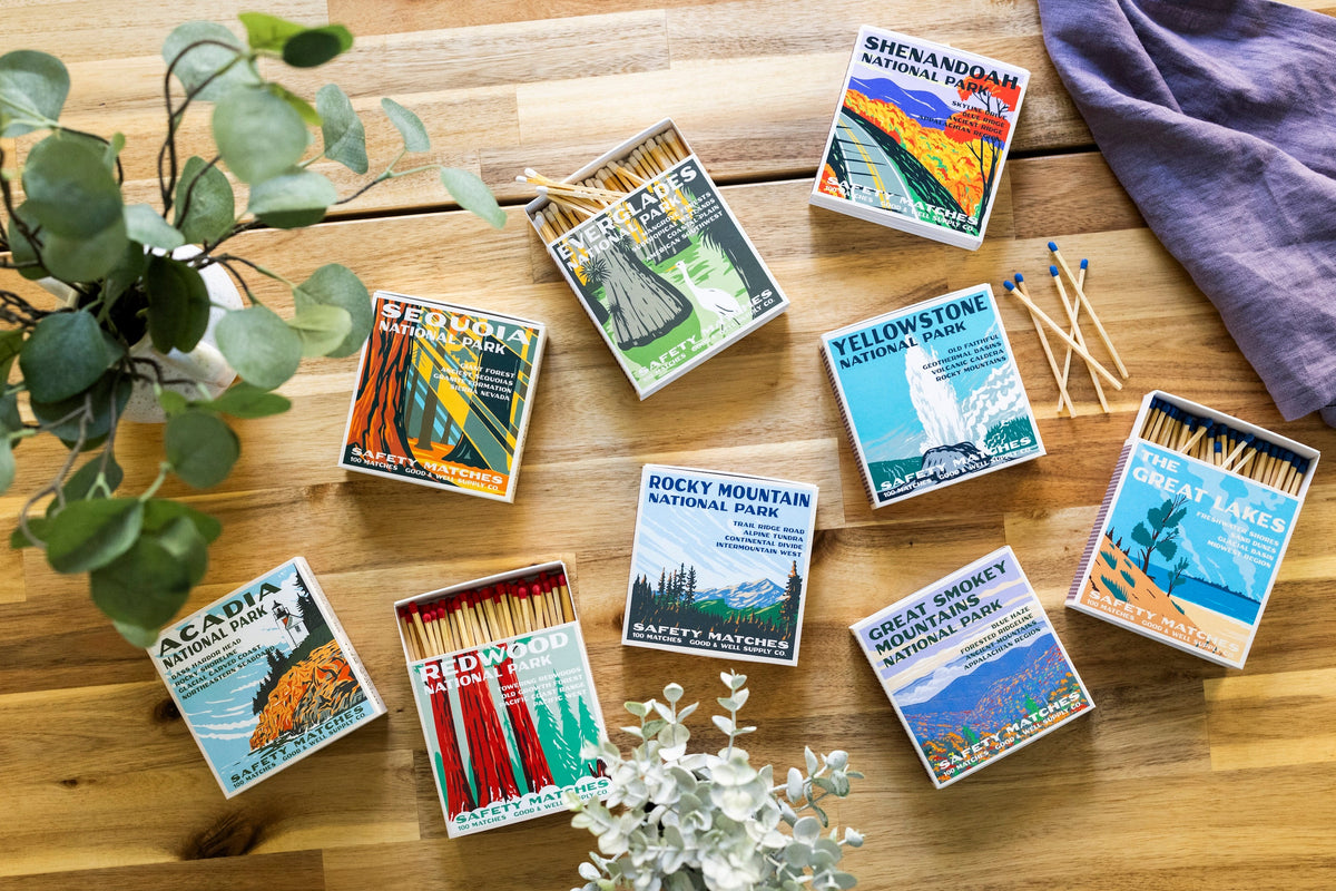 Assorted park-themed safety match boxes with wooden matches on a table