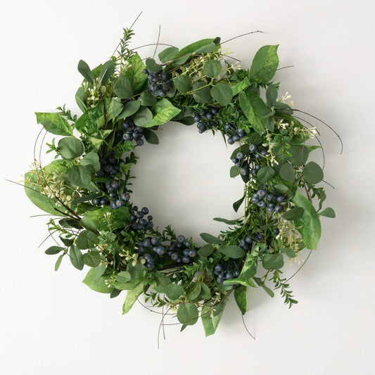 Artificial greenery wreath with dark blue berry clusters and green leaves